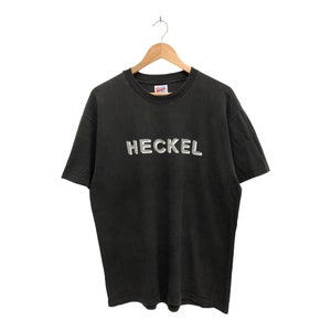May include: Black t-shirt with a white "HECKEL" logo printed on the front.