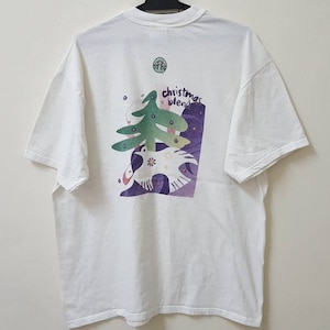 May include: White t-shirt with a green Christmas tree and the text "Christmas Blend" printed on the back.