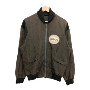 May include: A dark green and black bomber jacket with a zipper closure and a circular patch that says "IMPUL" in white letters.