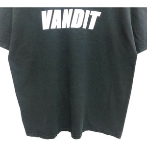 May include: Black t-shirt with the word "VANDIT" printed in white on the front.
