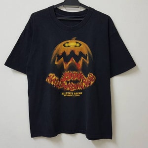May include: Black t-shirt featuring a graphic of a jack-o'-lantern with the text "Boo Halloween" and "Allstate Arena October 31, 2009".