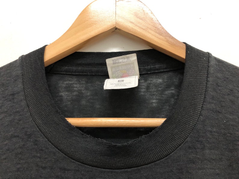 May include: Black t-shirt with a faded look and a white tag that says "Liquid Blue" with a small graphic of a star.