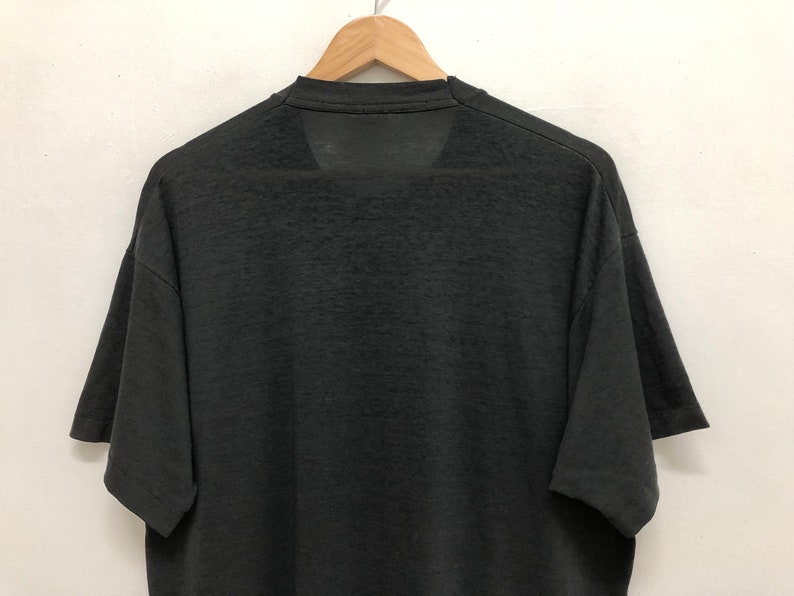 May include: A black short-sleeved t-shirt with a crew neck.