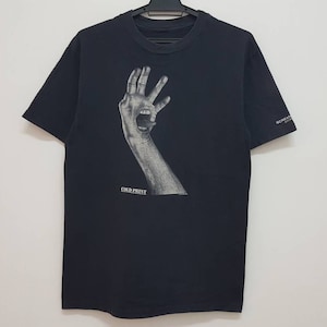 May include: Black t-shirt with a graphic print of a hand with a mouth on it. The text "Cold Prey" is printed below the graphic.