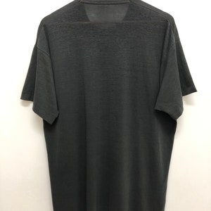 May include: A black short-sleeved t-shirt with a crew neck.