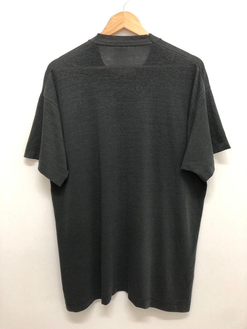 May include: A black short-sleeved t-shirt with a crew neck.