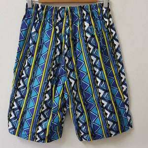 May include: Blue, yellow, and white patterned shorts with a geometric design.
