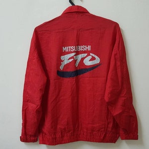 May include: Red windbreaker jacket with a white "MITSUBISHI FTO" logo on the back.