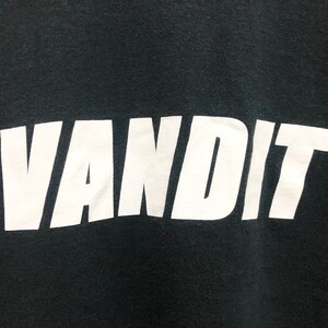 May include: Black t-shirt with the word "VANDIT" printed in white.