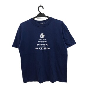May include: A navy blue t-shirt with a white graphic of a snake and the word "Piton" repeated four times.