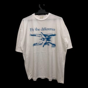 Vintage 90s KLM koninklijke luchtvaart maatschappij royal dutch airlines fly the difference promo tee beauty graphical single stitch tee