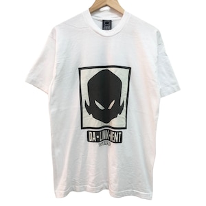 May include: White t-shirt with a black and white graphic of a face with the text "DA-INK'N'ENT" underneath.