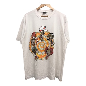 May include: White t-shirt featuring a graphic print of six cartoon faces surrounded by flames. The faces are all different colours and have different expressions. The text "3" is on the top of one of the faces.