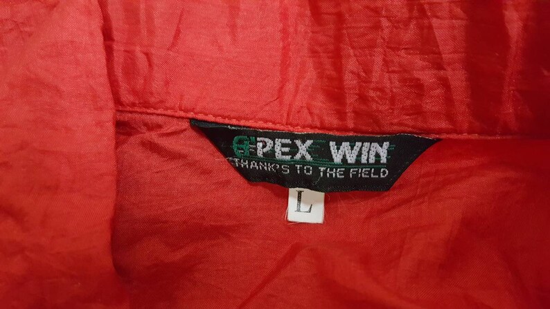 May include: A red jacket with a black tag that says "GPEX WIN THANKS TO THE FIELD" and a size "L" tag.