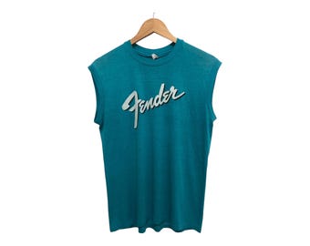Camiseta sin mangas promocional con el logotipo de Fender Guitars de los años 80, de material suave y fino, con un bonito color pop rave, fabricada en EE. UU., con el héroe de la guitarra rockstar Stedman
