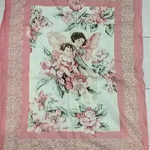 May include: A pink floral quilt with a central design of two winged cherubs surrounded by pink flowers and green leaves. The quilt has a light pink border and a patterned inner border.
