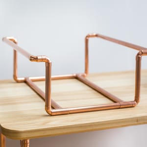 Vinyl record collection holder that is freestanding, ideal for a table top. It is made from polished copper pipe, and allows you to flick through your records whilst still displaying the covers.