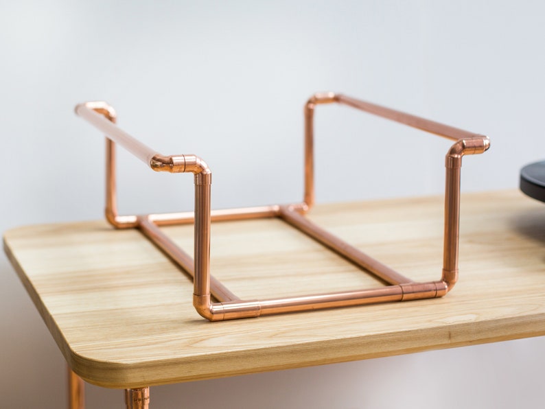 Vinyl record collection holder that is freestanding, ideal for a table top. It is made from polished copper pipe, and allows you to flick through your records whilst still displaying the covers.
