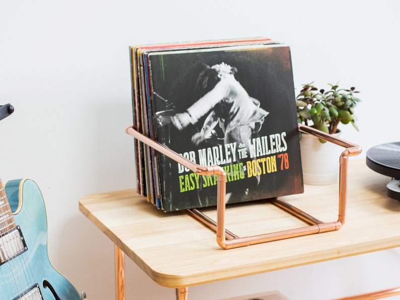 Vinyl record collection holder that is freestanding, ideal for a table top. It is made from polished copper pipe, and allows you to flick through your records whilst still displaying the covers.