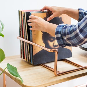 Vinyl record collection holder that is freestanding, ideal for a table top. It is made from polished copper pipe, and allows you to flick through your records whilst still displaying the covers.