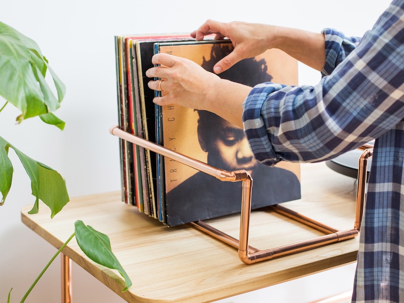 Vinyl record collection holder that is freestanding, ideal for a table top. It is made from polished copper pipe, and allows you to flick through your records whilst still displaying the covers.
