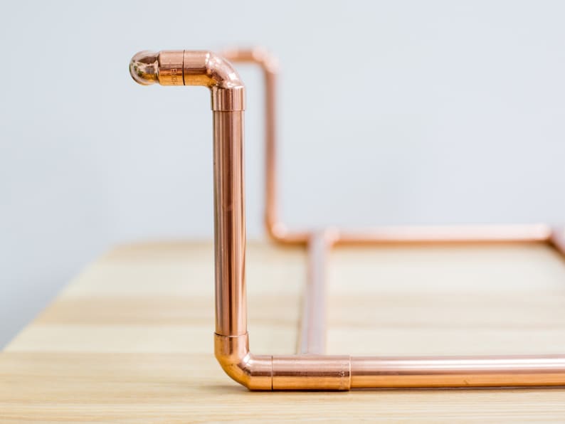 Vinyl record collection holder that is freestanding, ideal for a table top. It is made from polished copper pipe, and allows you to flick through your records whilst still displaying the covers.
