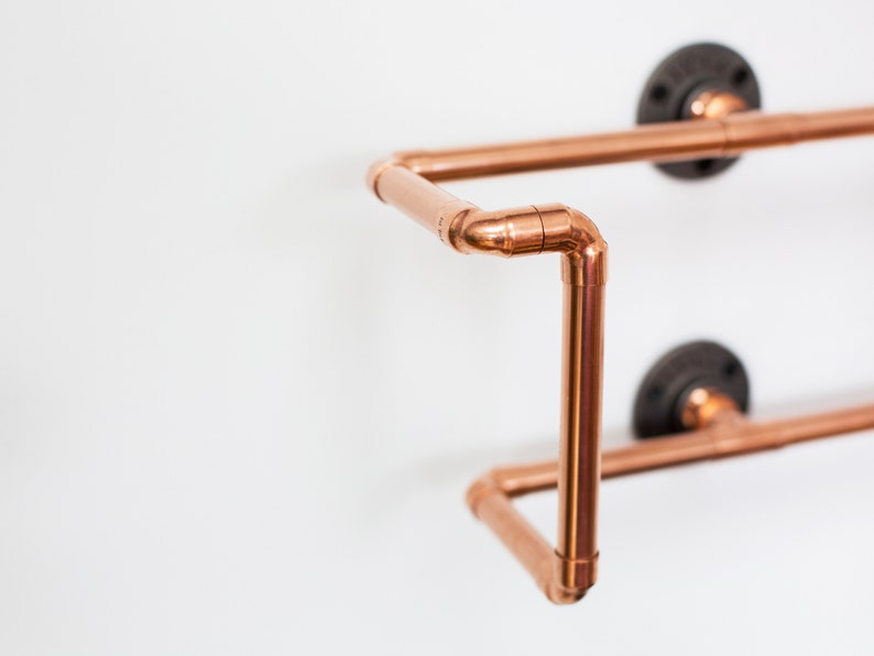 Vinyl record  holder that is wall mounted, ideal for holding up to 15 records. It is made from polished copper pipe, and allows you to flick through your records whilst still displaying the covers.