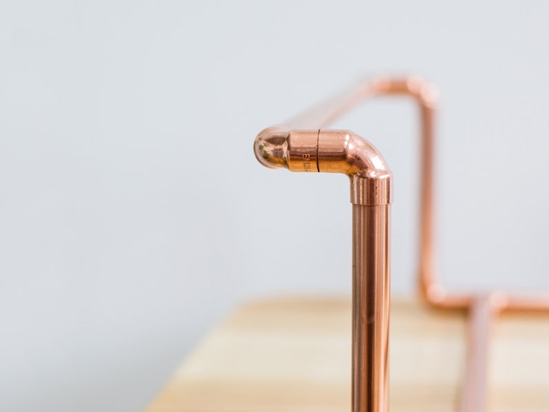 Vinyl record collection holder that is freestanding, ideal for a table top. It is made from polished copper pipe, and allows you to flick through your records whilst still displaying the covers.