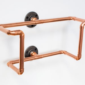 Vinyl record  holder that is wall mounted, ideal for holding up to 15 records. It is made from polished copper pipe, and allows you to flick through your records whilst still displaying the covers.