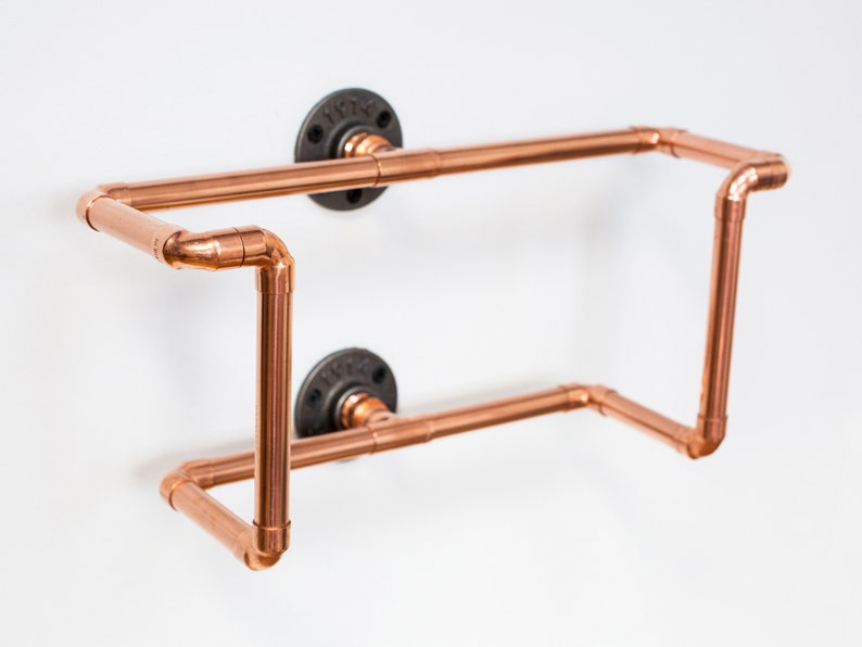 Vinyl record  holder that is wall mounted, ideal for holding up to 15 records. It is made from polished copper pipe, and allows you to flick through your records whilst still displaying the covers.