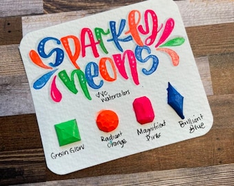 May include: Sparkly Neons watercolour set with five colours: Green Glow, Radiant Orange, Magnificent Pink, Brilliant Blue. The set includes a small sample of each colour.