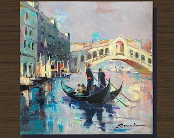 May include: Oil painting of a Venetian canal scene with a gondola, bridge, and buildings. The artwork features a gondola with passengers and gondoliers, a white bridge, and buildings with blue and green hues. The water reflects the sky and buildings.