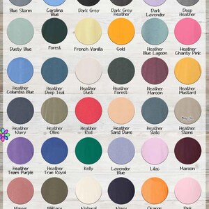 The image is a color swatch for a clothing item called a "Premium Hoodie". It displays a variety of different colored hoodies, including black, blue, green, orange, and pink, among others. The image also includes a woman wearing a hoodie, which adds a visual element to the color swatch. The image does not contain any text, and the focus is on the colors and the woman's presence.