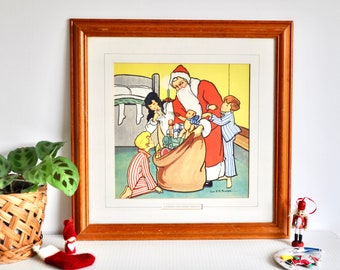 May include: A framed vintage Christmas illustration depicting Santa Claus delivering gifts to three children in their pajamas. Santa is wearing a red suit with white trim and a white beard. The children are looking up at Santa with excitement. The illustration is set in a bedroom with a bed in the background.