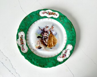 Vintage Limoges style green and gold porcelain plate with romantic scene 1980s