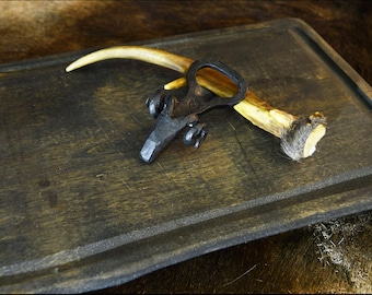 Hand forged ram bottle opener