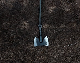 Hand forged double-edged barbarian axe necklace, with high quality elk leather string.