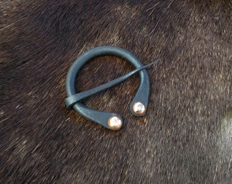 Hand forged viking horseshoe brooch with copper rivets