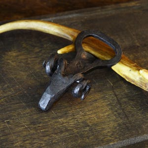 Hand forged ram bottle opener