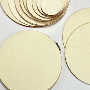 May include: A set of wooden circles of varying sizes, perfect for crafting projects. The circles are made of natural wood and have a smooth, unfinished surface.