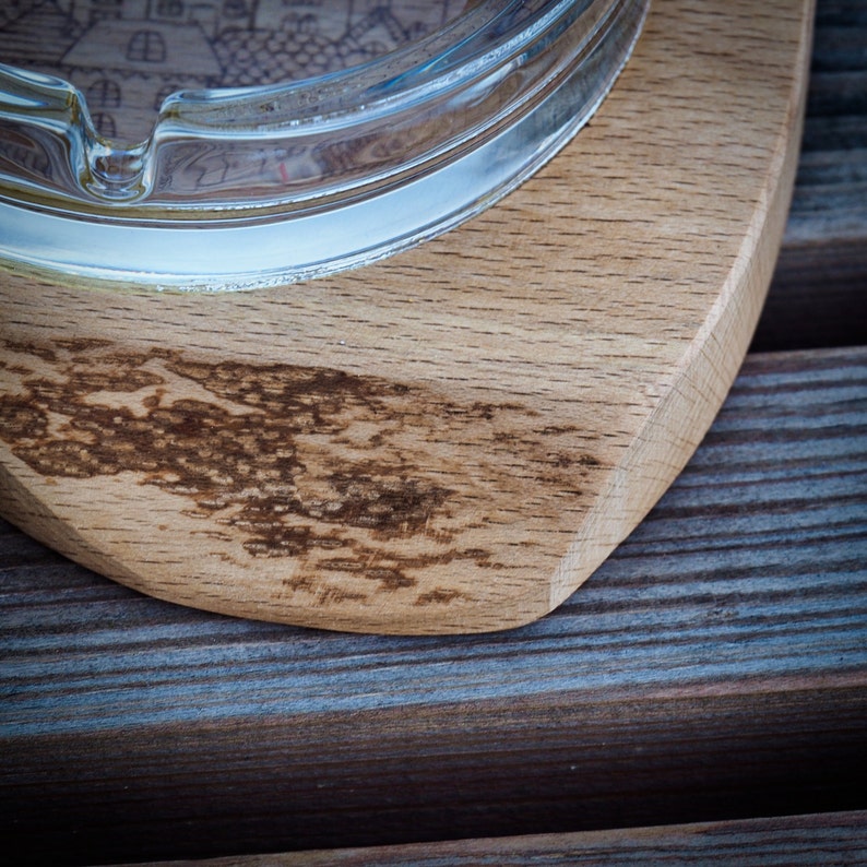 Glass ashtray on handmade wooden pad