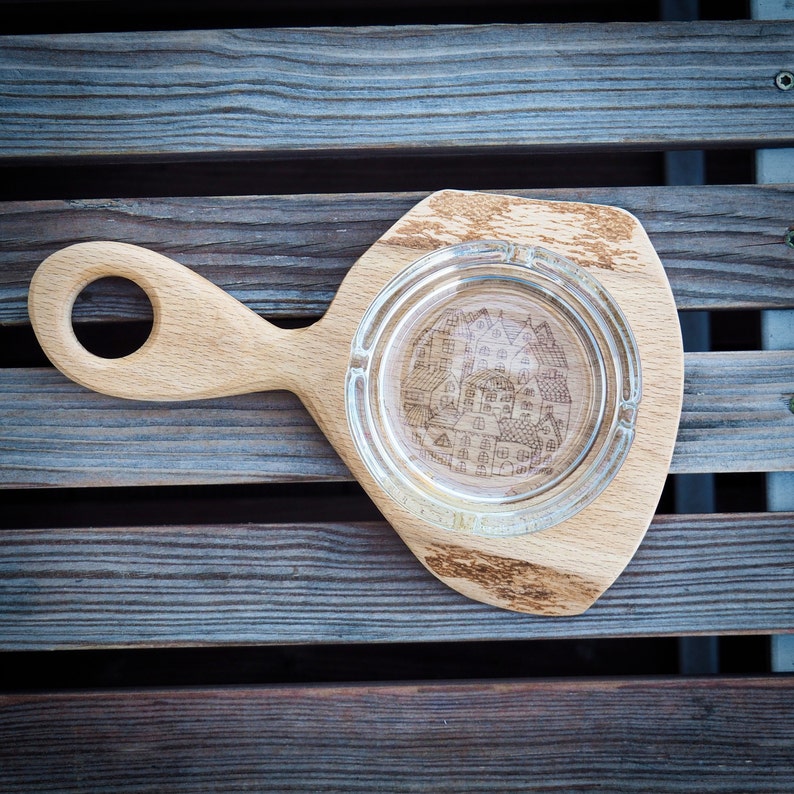 Glass ashtray on handmade wooden pad