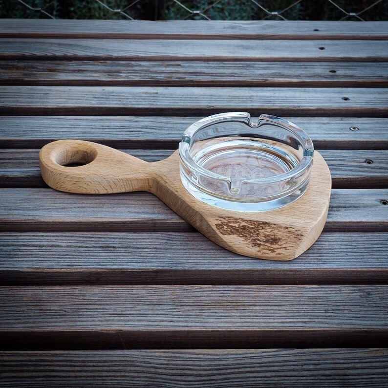 Glass ashtray on handmade wooden pad