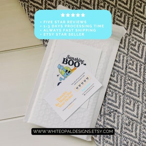 May include: A white envelope with a sticker of a cartoon character holding a book and a trumpet. The sticker says "Sunshine Boo". The envelope also has a business card with the text "Thanks so much for your order! I'd love your feedback on Etsy" and a discount code offer. The text "WWW.WHITEOPALDESIGNS.ETSY.COM" is printed on the envelope.