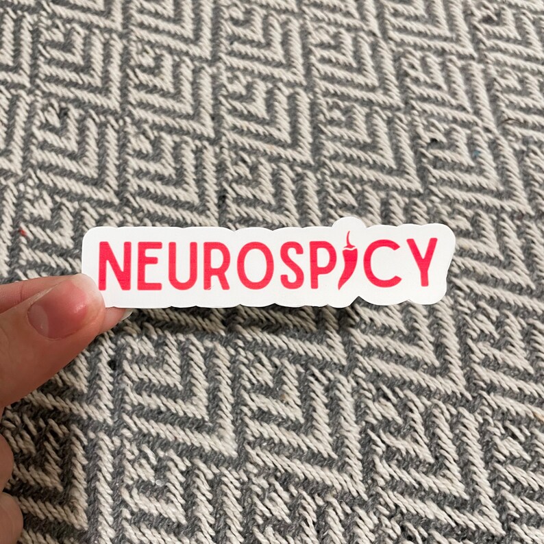 May include: White sticker with the text "NEUROSPICY" in red lettering and a red chili pepper icon.
