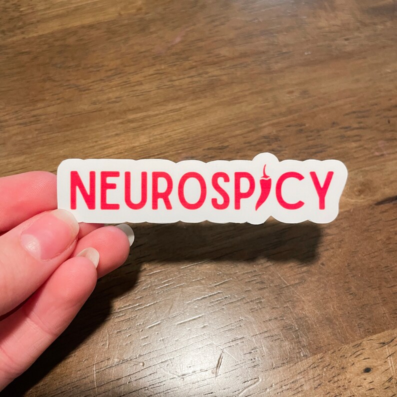 May include: White sticker with the text "NEUROSPICY" in red lettering and a red chili pepper icon.
