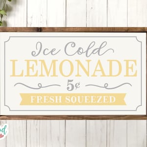May include: A wooden sign with a white background and a brown frame. The sign says "Ice Cold Lemonade 5&cent; Fresh Squeezed" in yellow and gray lettering.