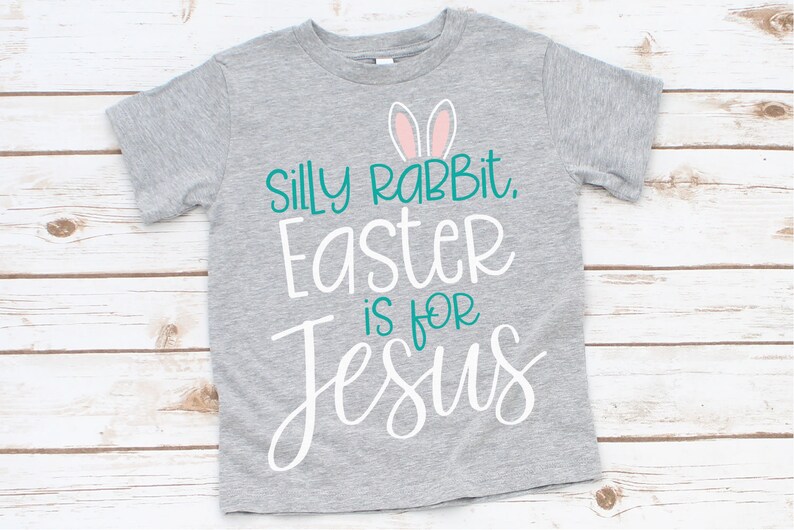 May include: Gray t-shirt with a white graphic that says "Silly Rabbit, Easter is for Jesus" with pink bunny ears above the text.