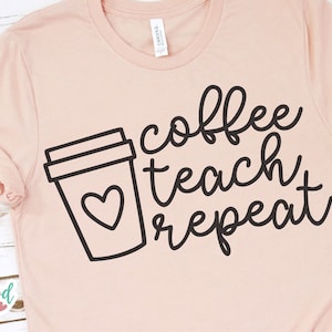 May include: A pink t-shirt with a black outline of a coffee cup with a heart inside and the text "coffee teach repeat" in black cursive writing.
