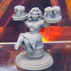 May include: A gray figurine of a woman sitting on a barrel, holding two trays of beer mugs. The woman is wearing a dress and has a cheerful expression.